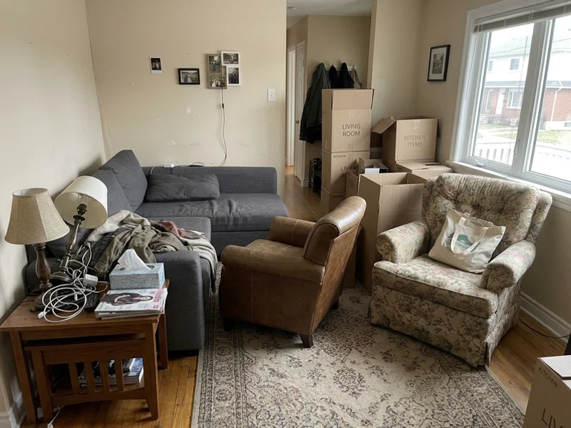 Living room crowded with old furniture before removal