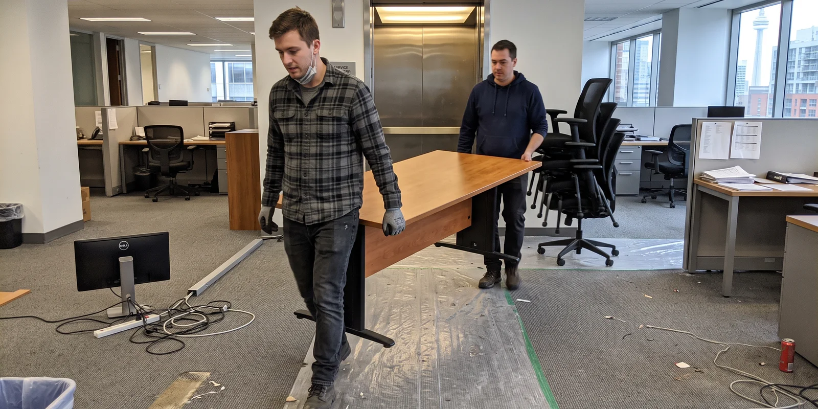 Crew clearing desks and chairs from a Toronto office floor